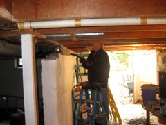 man refinishing wood floor